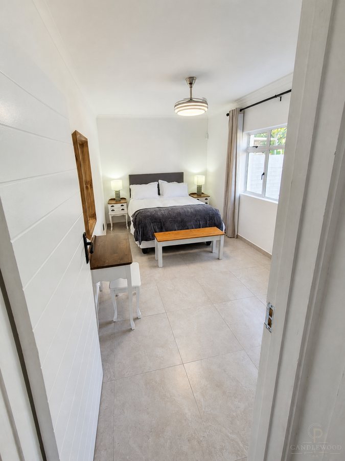 Second queen bedroom with a bench at the foot of the bed