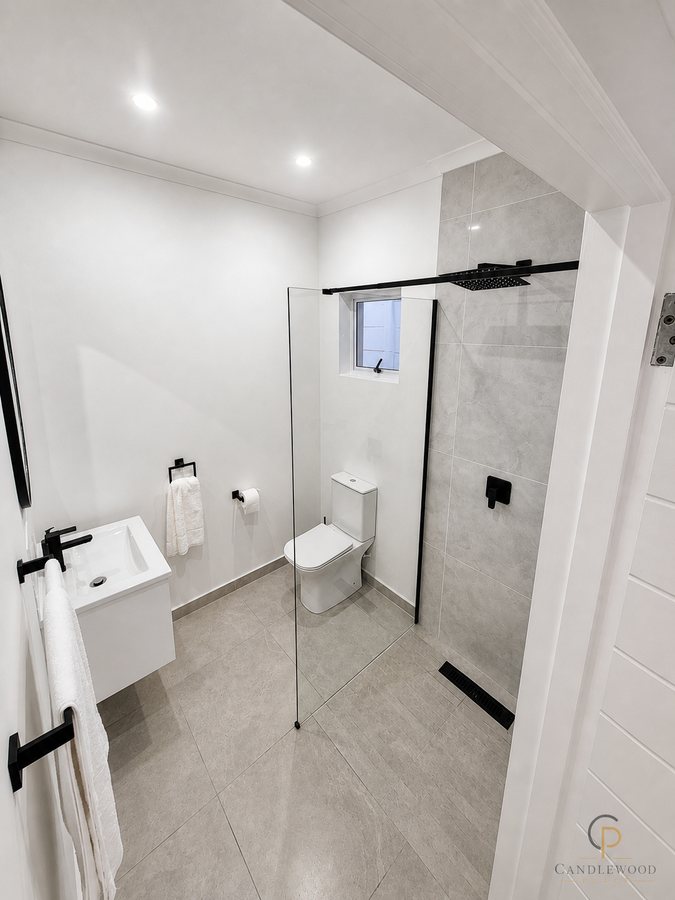 Ensuite bathroom with a frameless walk-in shower and floating basin