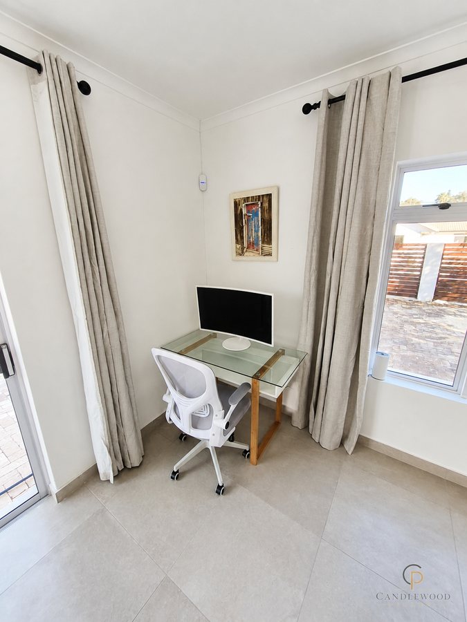 Dedicated desk with a large monitor and ergonomic chair